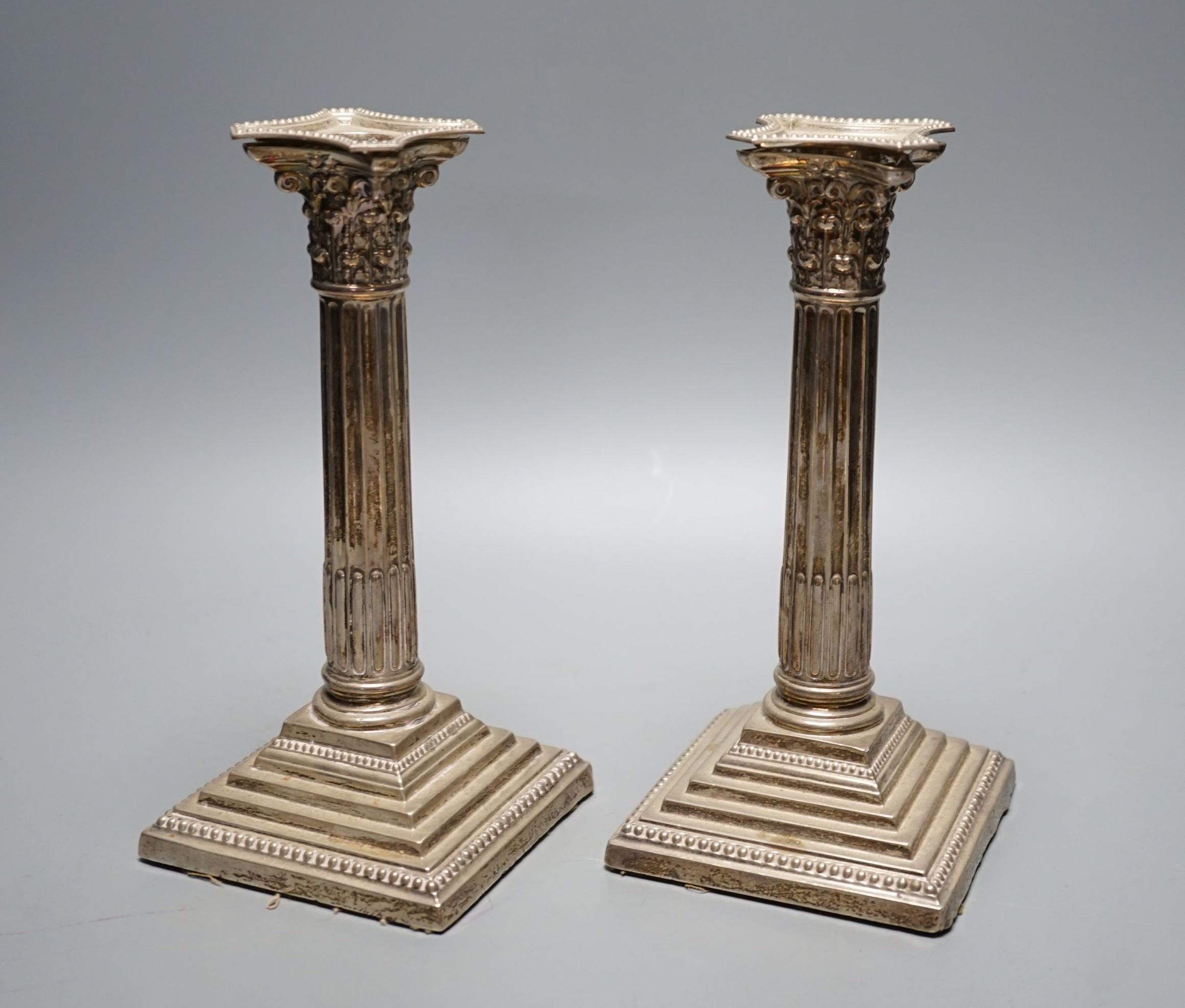 A pair of George V silver Corinthian column candlesticks, Robert Pringle & Sons, Sheffield, 1930, height 21.6cm, weighted.